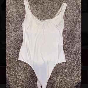Bodysuit with crystals around the neckline